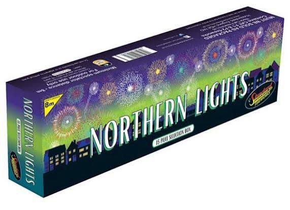 A box of Northern Lights 8m fireworks selection box, featuring a purple and green design with colorful fireworks and house silhouettes, on a white background.